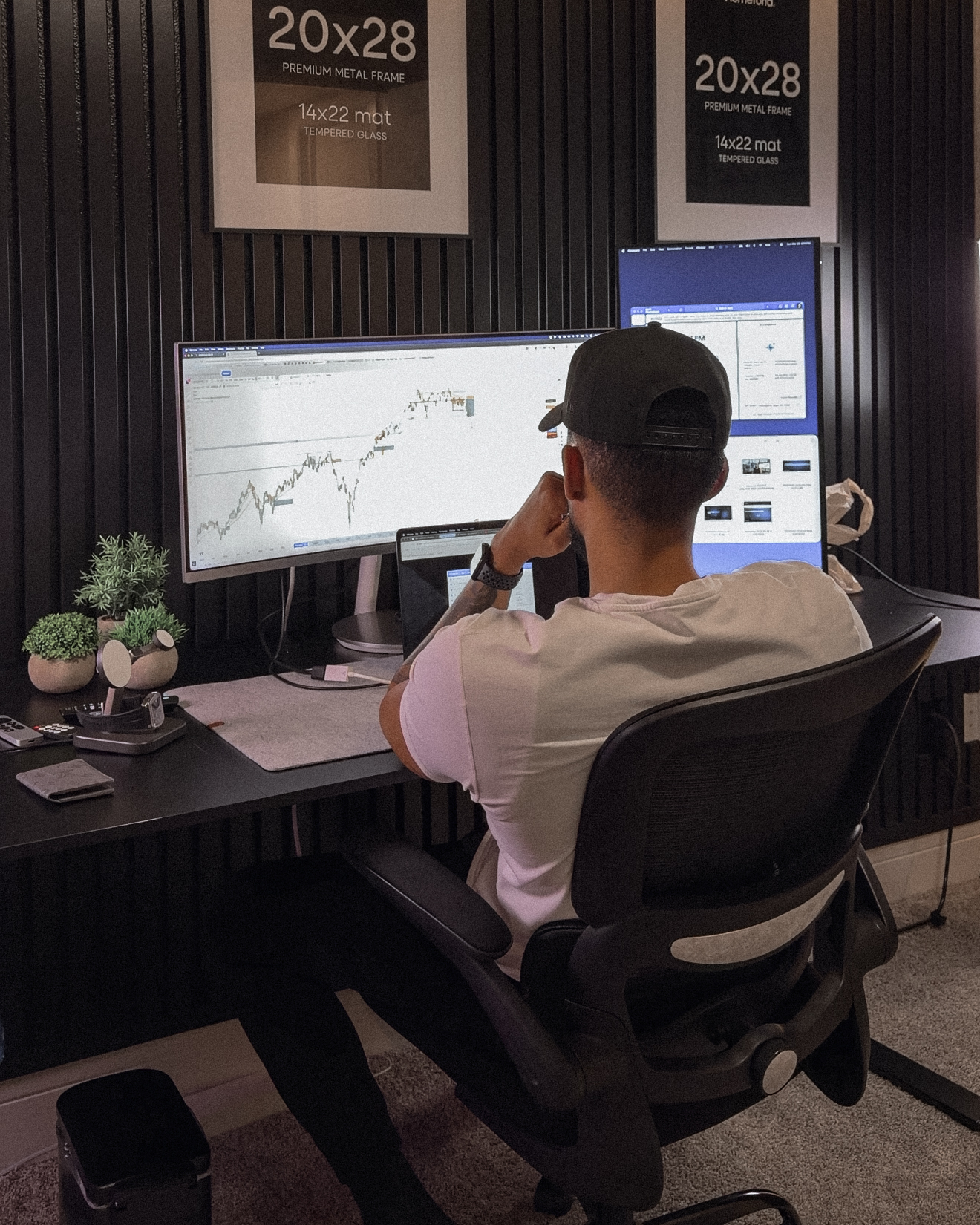 At the desk reading a live chart on the ultrawide — calm, focused, dialed in