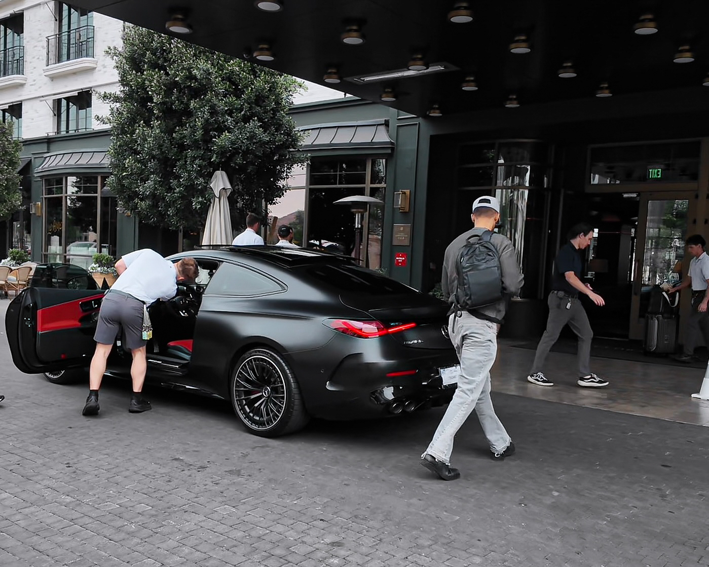 Handing the matte-black AMG to the valet at the hotel entrance