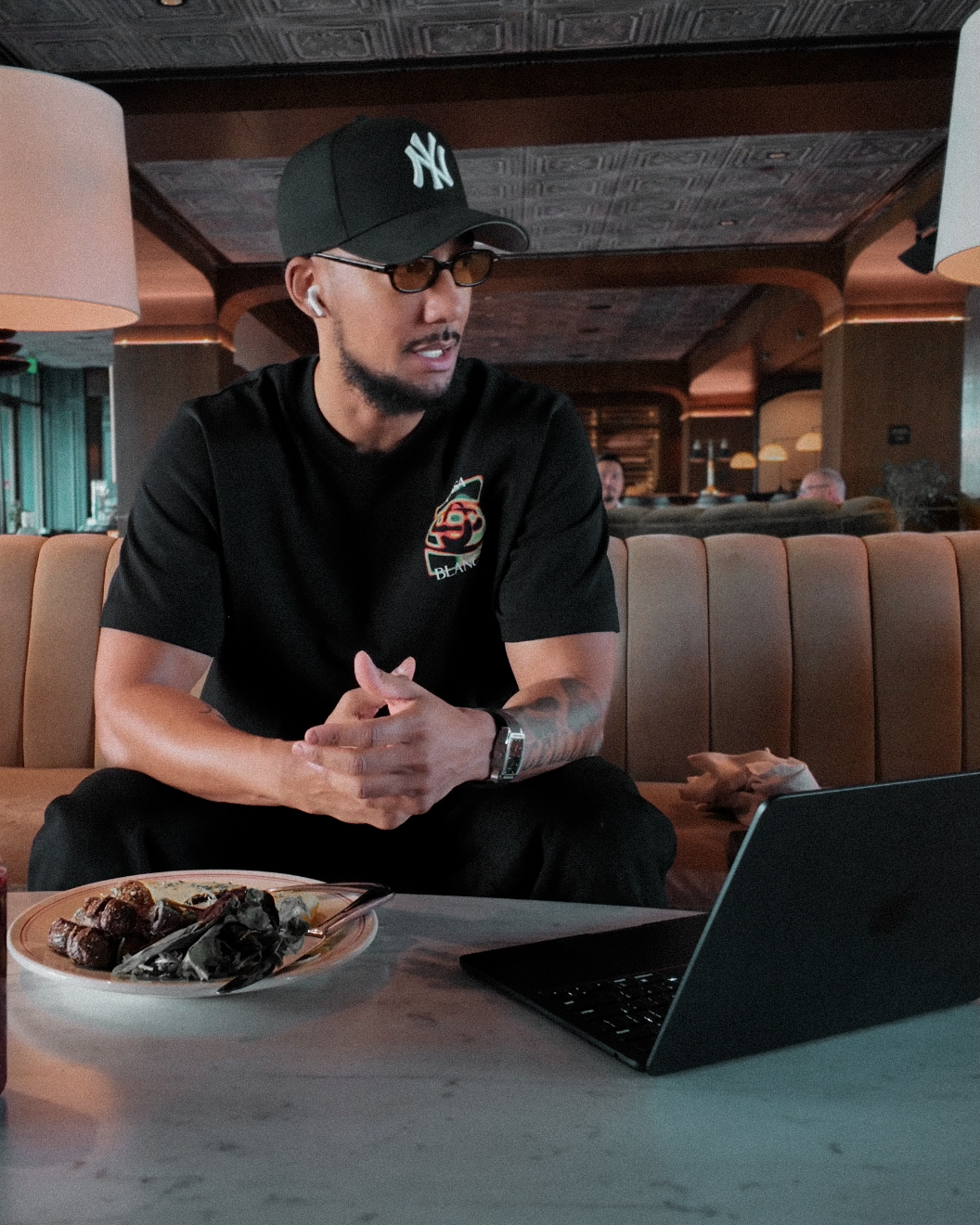 Nate Barnes, founder of FRFW, working on his laptop in a lounge